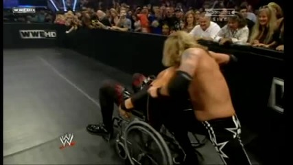 Edge throughs Kane into the barricade with the Wheelchair