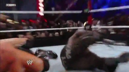 R-truth breaks a Sharpshooter with a Little Jimmy