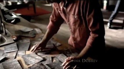 Damon and Elena play-fight while Alaric looks at photos of the cave drawings.