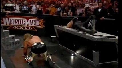 Shawn Michaels hits a Sweet Chin Music followed by a Moonsault into the Announcer Table
