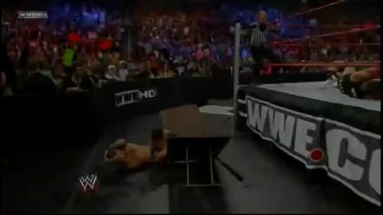 The Miz throws Alex Riley on Randy Orton through a Table
