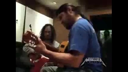 Robert Trujillo playing an acouistic guitar