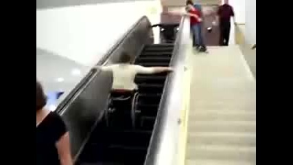 Guy falls down escalator in wheelchair 