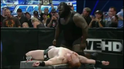 Mark Henry hits a World Strongest Slam on Sheamus into the Steel Steps