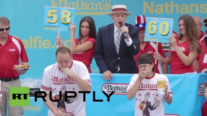 USA: See competitive eater chow down 62 hot dogs in 10 minutes