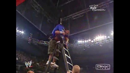 John Cena прави Fu на Edge от стълба и чупи две маси. 