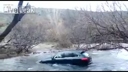 Идиот с Porsche Cayenne се опитва да премине през реката.