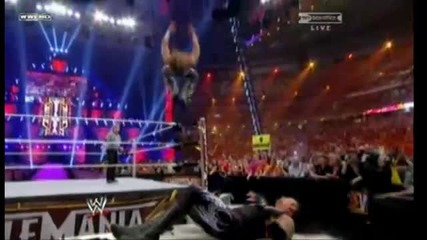 Shawn Michaels hits a Sweet Chin Music followed by a Moonsault into the Announcer Table