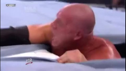 Undertaker takes Kane under the ring