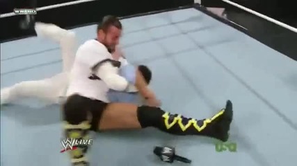 Cm Punk hits an Anaconda Vise on Michael Cole