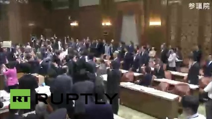 Japan: MPs scuffle in parliament as panel approves contentious security bill