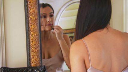 A teary-eyed Nikki Bella retreats upstairs after hearing JJ and Lauren's baby news at her engagement party: Total Bellas