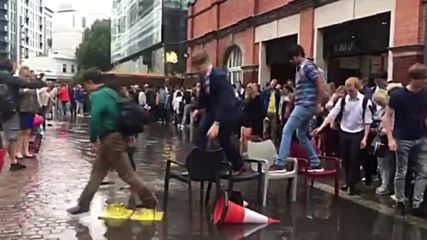 British summer strikes again! Londoners make chair bridge to avoid puddle