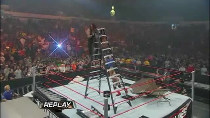 Edge throws The Undertaker off a Ladder throught four Tables