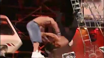 John Cena hits a Fu on The Great Khali off a tractor to the concrete
