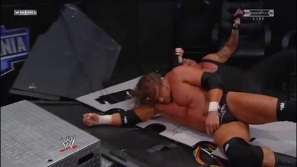 Triple H Spinebusters Undertaker into the Announcer Table