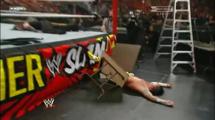 Jeff Hardy throws Cm Punk through a Table