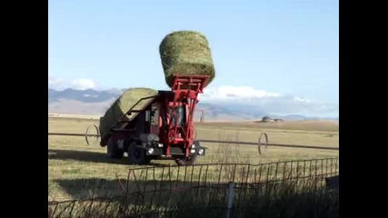 Truck picking up hay bales in Montana 