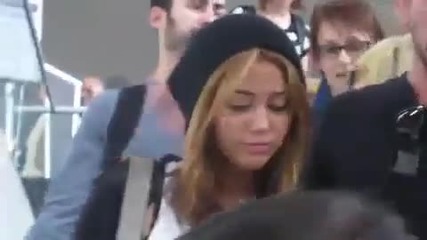 Miley Cyrus with boyfriend Liam Hemsworth Arrive at Lax amid creaming 2011 