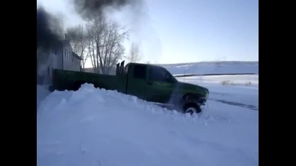 Пикап Додж John Deere срещу купчина сняг 